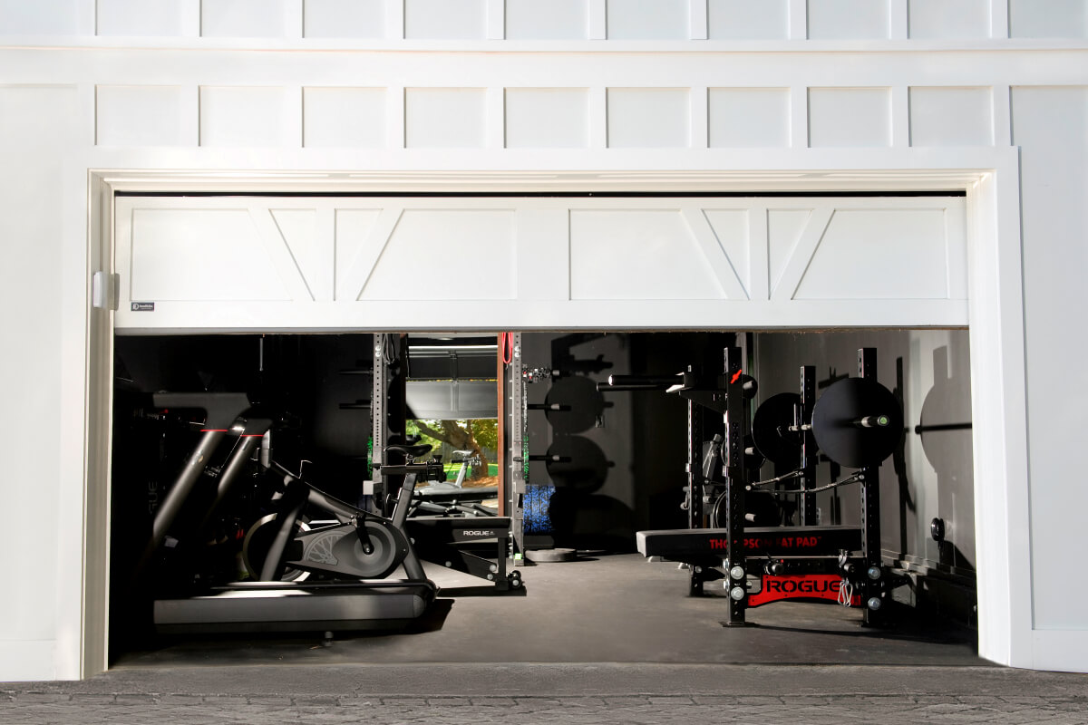 This Garage Door was Designed to Complement both the Exterior of his Home and the Interior of the Exercise Area